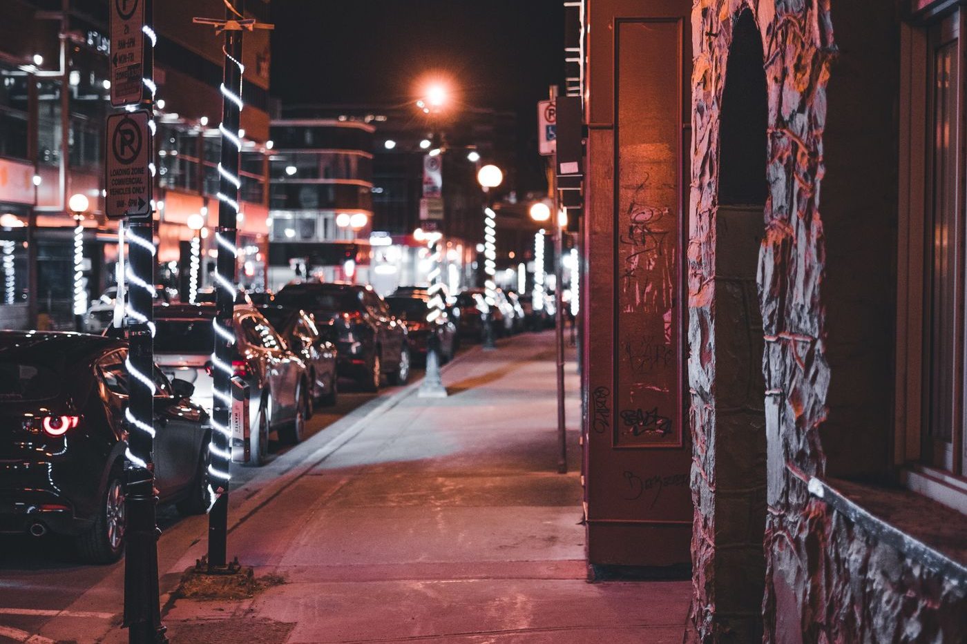 Sidewalk lit by street lamps at night