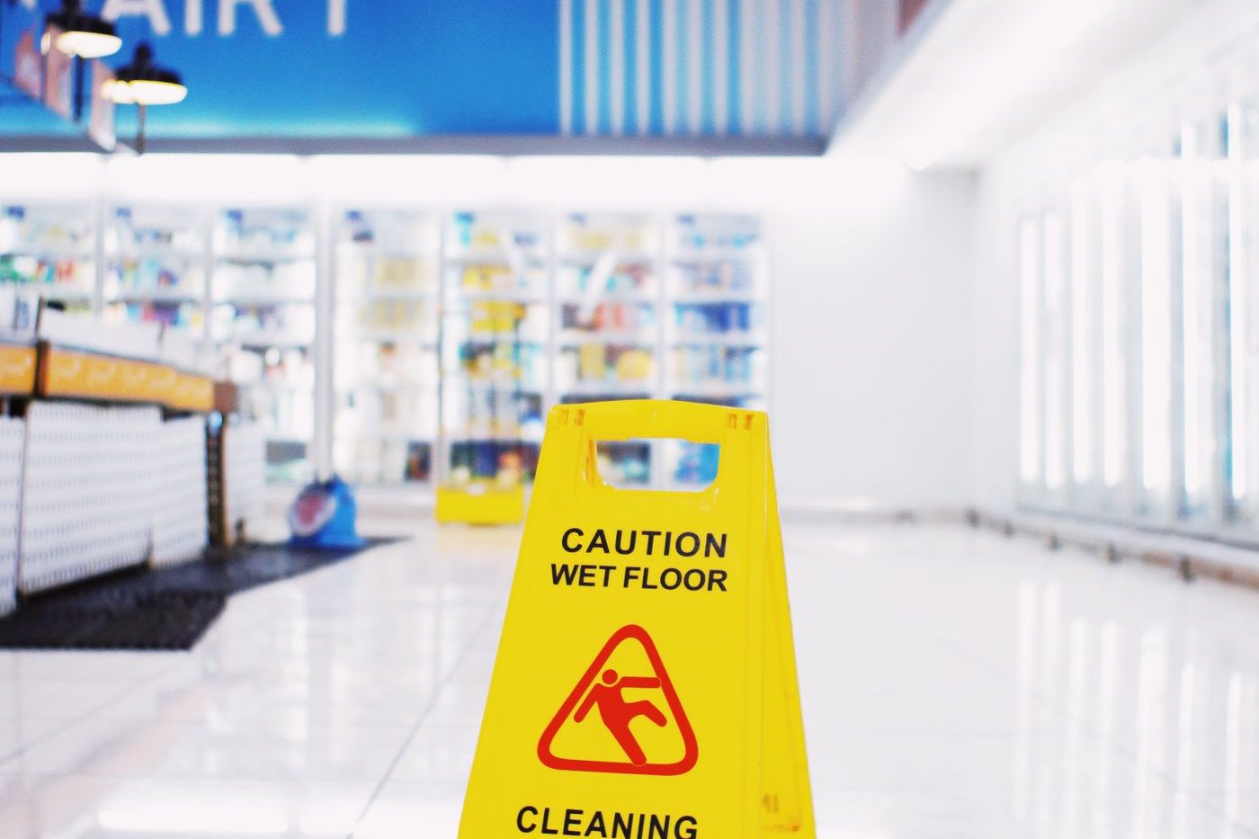 Yellow caution wet floor sign on a tile floor