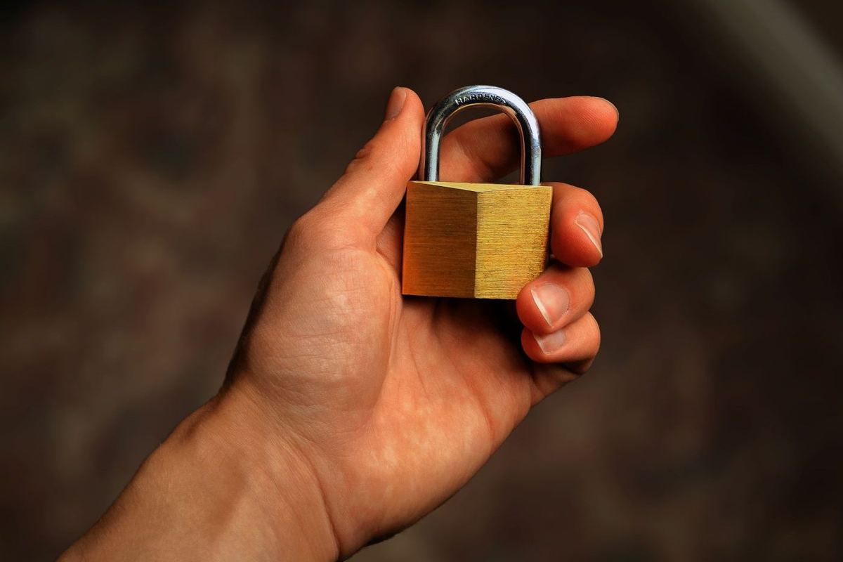 Hand holding a padlock